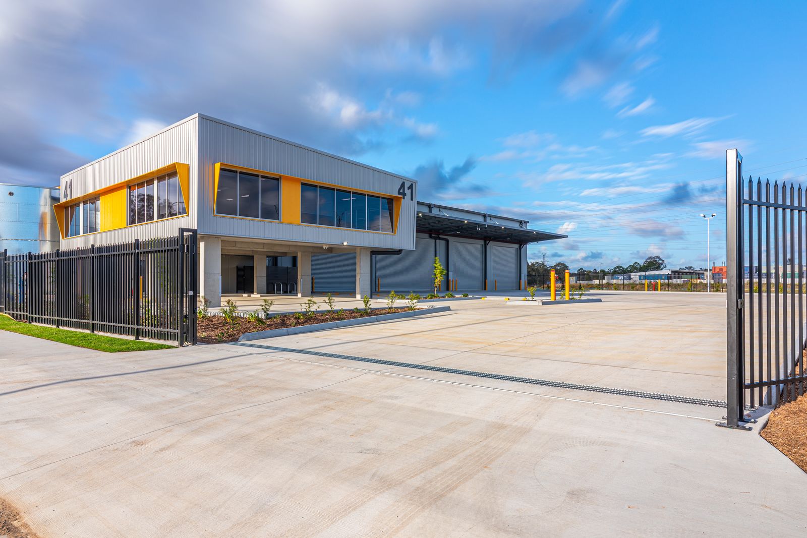 Industrial site with landscaped frontage, kerbing and paving